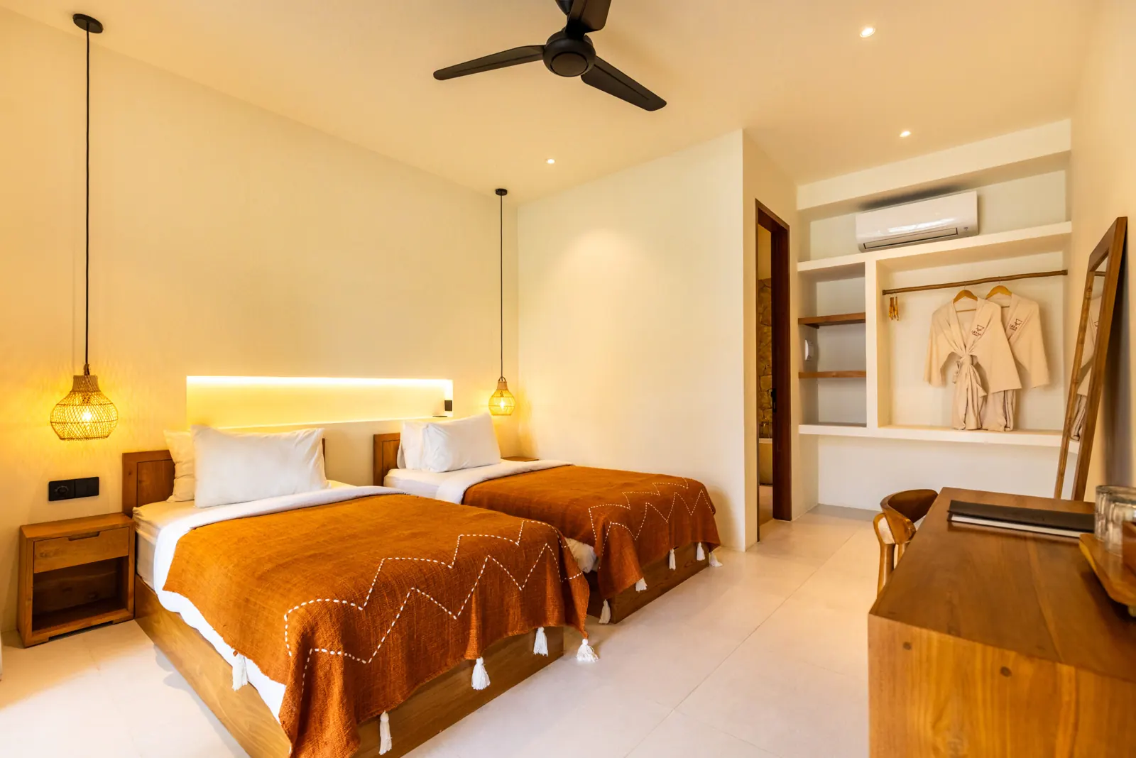Deluxe Twin Room with two single beds under orange throws