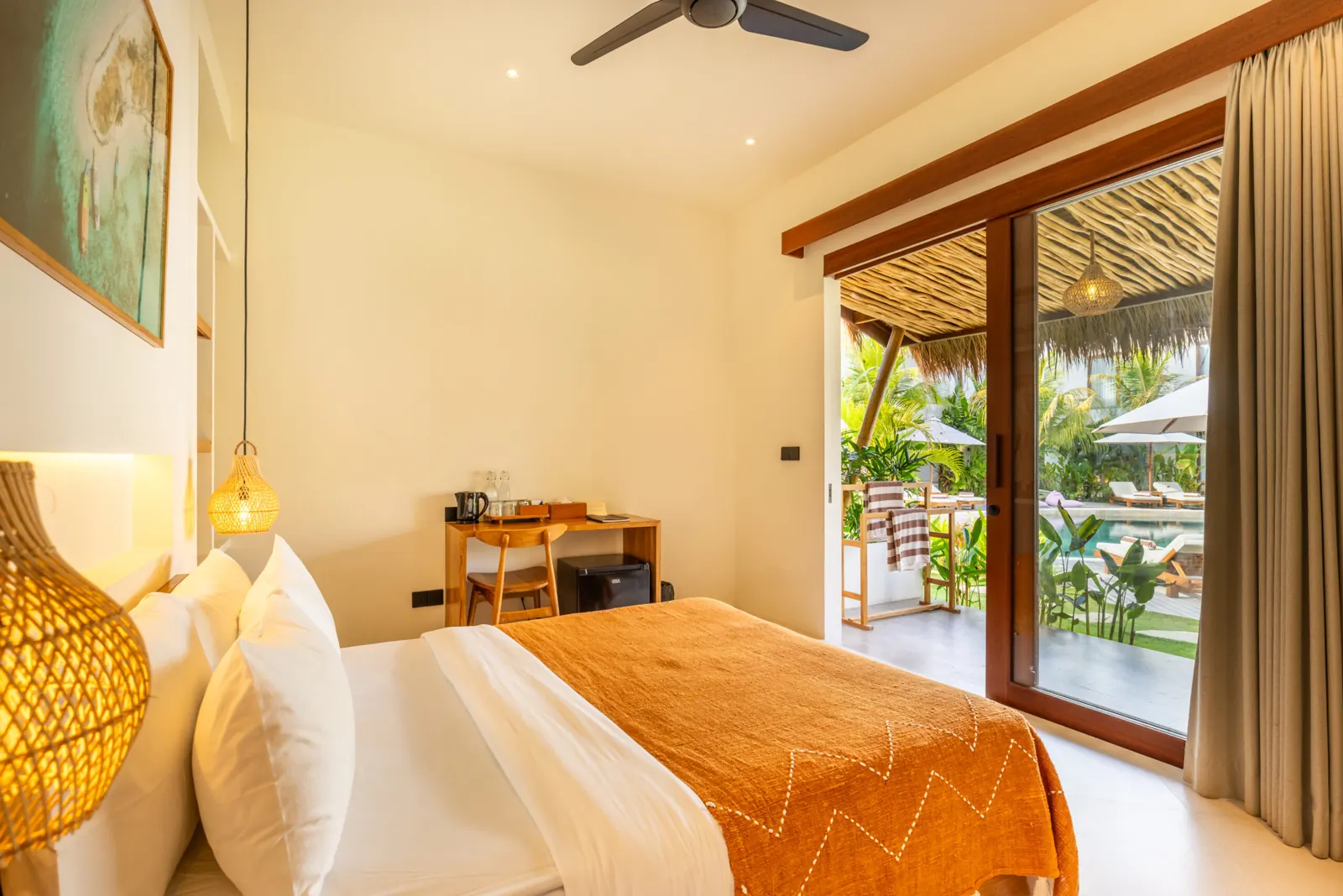 King bed beside sliding glass doors opening to the terrace