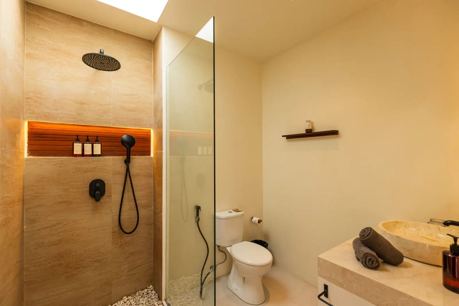 Bathroom with walk-in rain shower and stone washbasin