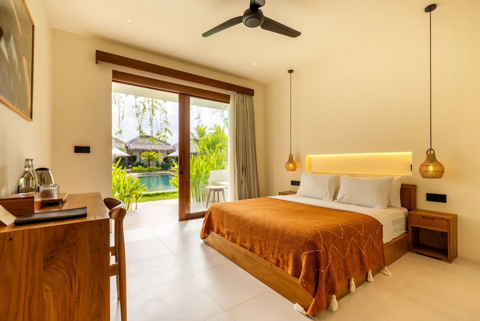 Double bed with desk and glass doors opening onto the garden