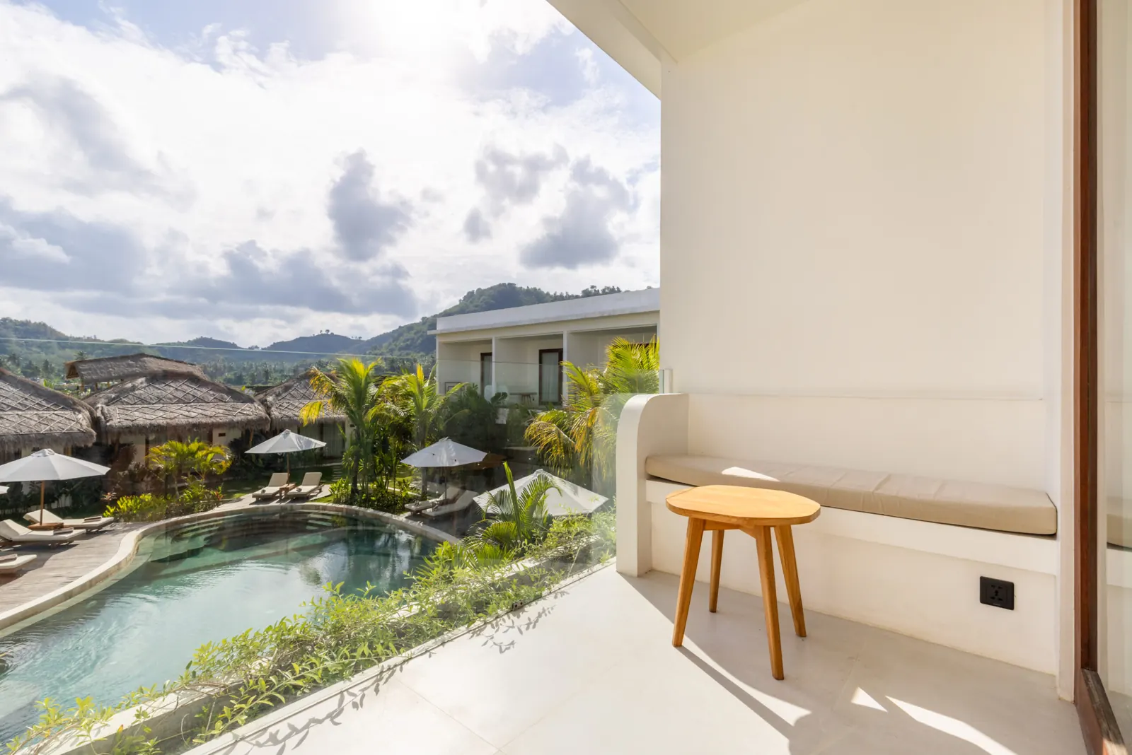 Terrace with bench and side table overlooking the pool